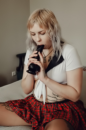 Sem Retlick Grabs Her Ass Enticingly In A Plaid Skirt And Black Pantyhose