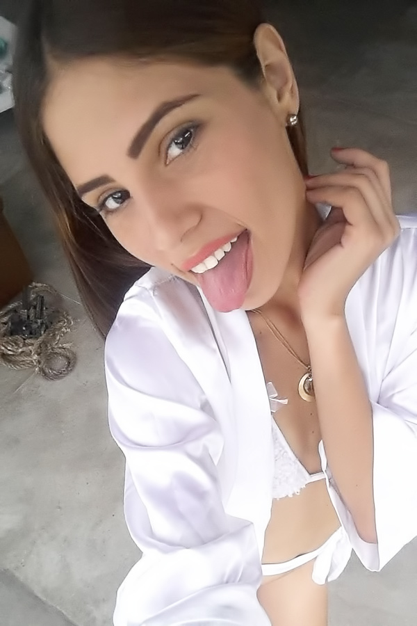 Mily Mendoza teases in white lingerie and robe with playful poses by the window indoors