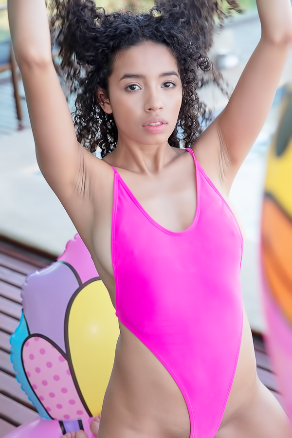Valery Ponce teases in pink bikini on inflatable, tongue out by the poolside, solo and playful