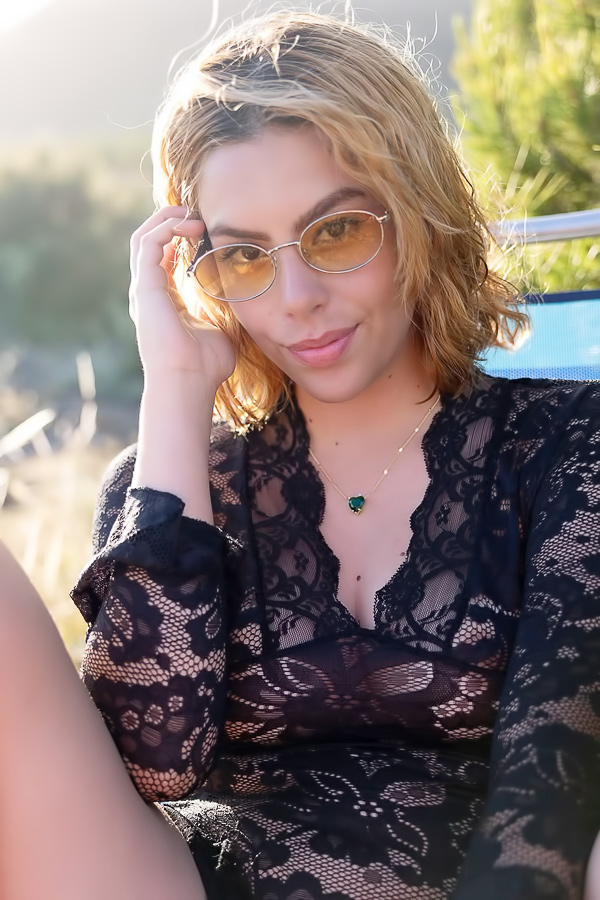 Sally Hunter teases in black lace outdoors, wind blowing her sheer top as she poses bare bottom