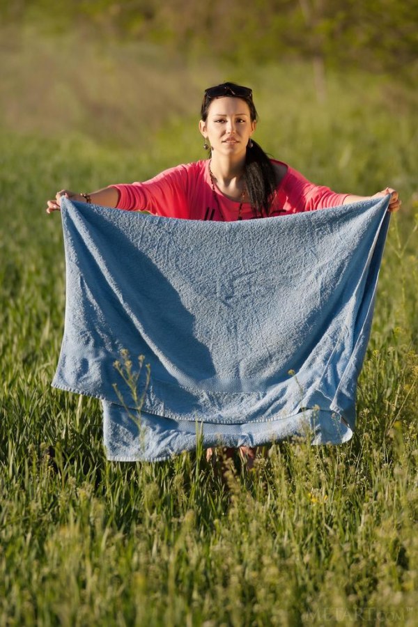Naked babe works out in field