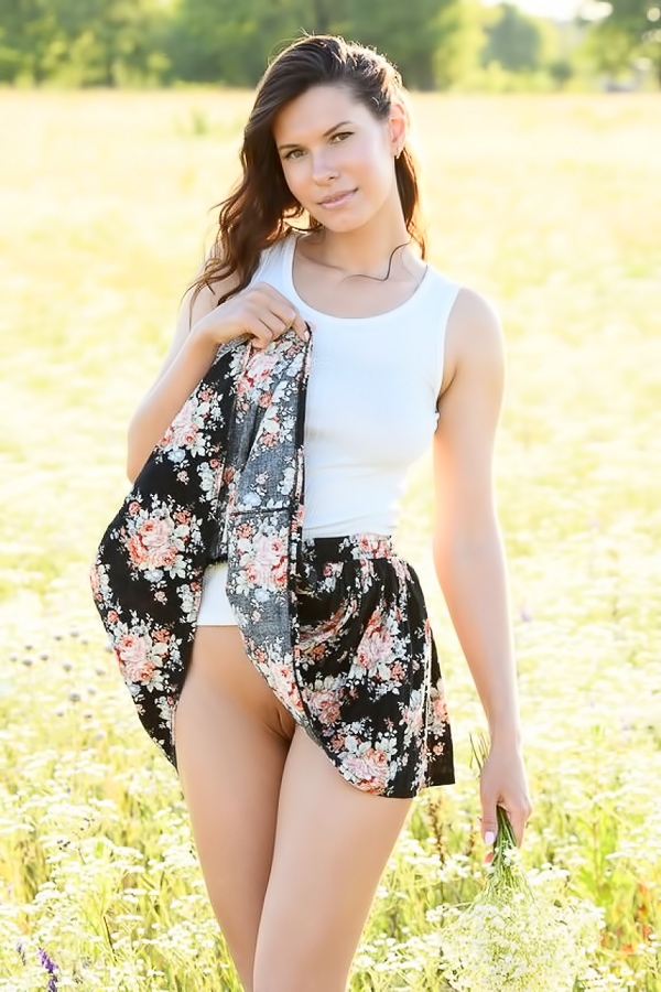 Naked babe lies down on blanket in the field