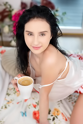 Sasha Jane teases languidly on the silk sheets, revealing her shaved pussy beneath the short shorts